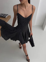 back-zip polka dot mini dress styled with a small handbag
