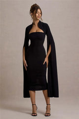Elegant black cape dress styled for evening occasions