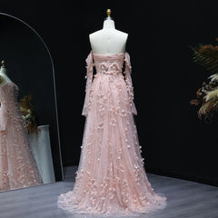 Pink evening gown with floral embroidery on a mannequin against a dark background