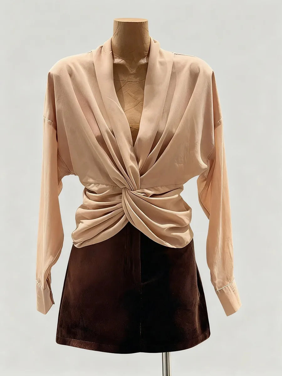 Front-facing silhouette showing the long sleeves and fluid structure of the blouse