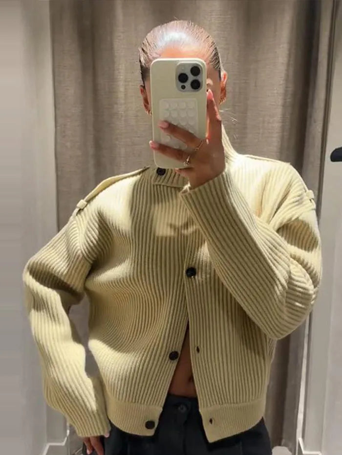 Close detail showing the ribbed knit texture and long sleeve finish