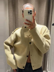 Close detail showing the ribbed knit texture and long sleeve finish