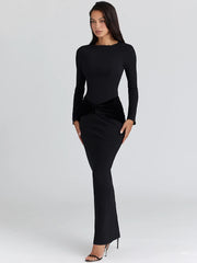 Close-up of waist ruching on a long-sleeve maxi dress showing sculpted contour and smooth floor-length silhouette.