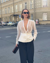 Long sleeve sheer-effect blouse styled with tailored trousers