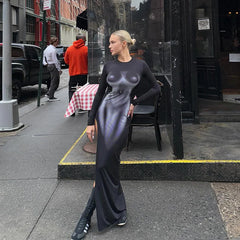 Woman in a slim fit floor-length printed dress with round neckline on a city street