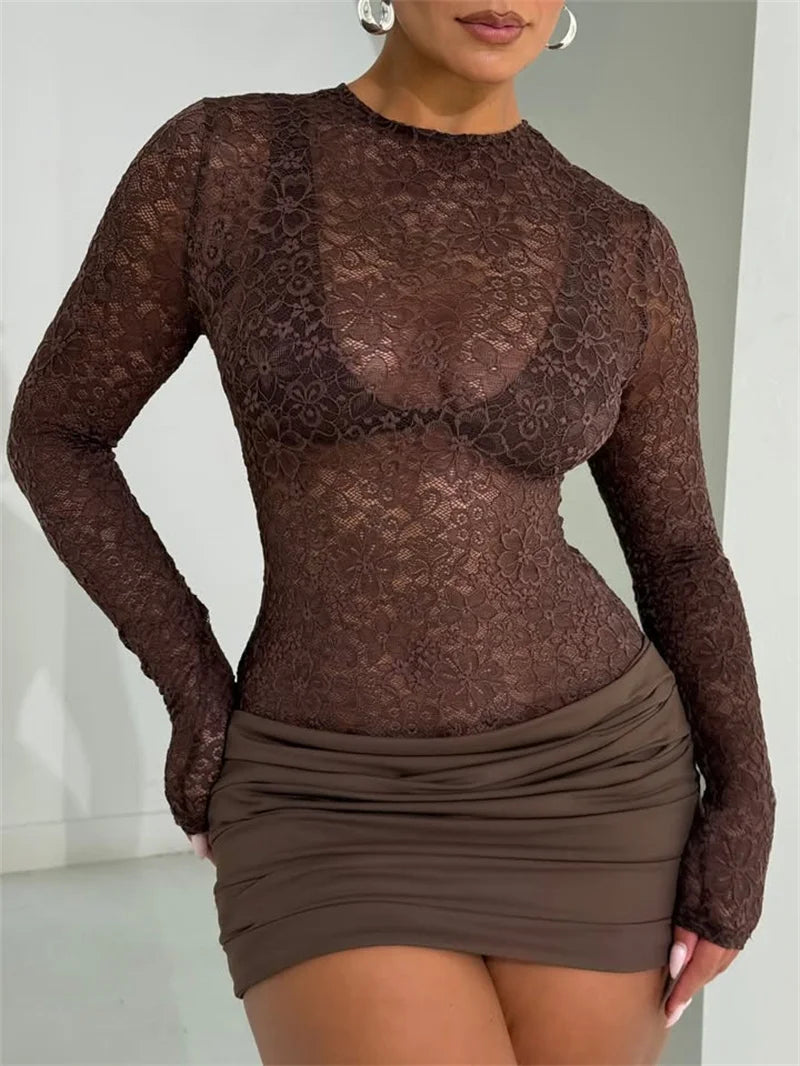 Full outfit shot showing the slim fit and ruched mini length of the brown lace dress against a soft curtain backdrop.