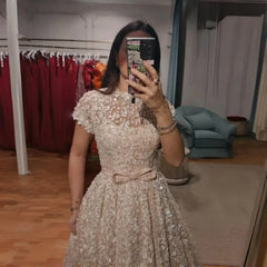 Person wearing a sparkly dress taking a mirror selfie in a room with clothes and furniture.