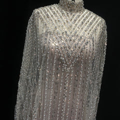 Luxury champagne sequin caftan party dress displayed in a  mannequin against a black background