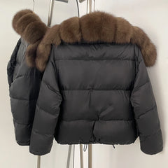 Natural fox fur collar detail on a thick winter puffer coat.