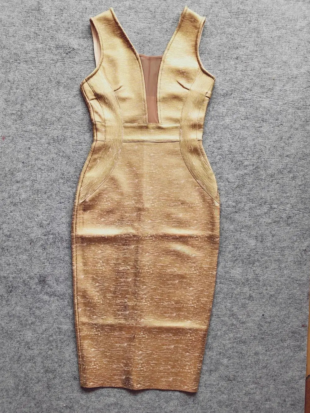 Luxury gold midi dress photographed to showcase the bold silhouette for special occasions

