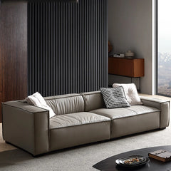 Modern design wooden frame leather sofa with a metal accent, displayed in a bright living room setting.