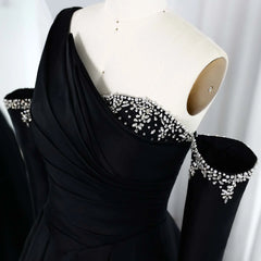 Luxury sequined Dubai party gown displayed for elegant occasions with crystal shoulder detailing on a mannequin against a white background