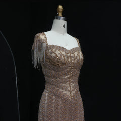 Mannequin wearing a beaded and fringed dress against a black background
