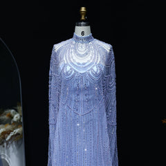 Mannequin wearing a sparkling blue dress with intricate patterns on a black background