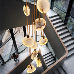 Marble-look vertical foyer chandelier in a luxury interior