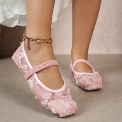 Pink lace shoes worn with a white skirt on a neutral background