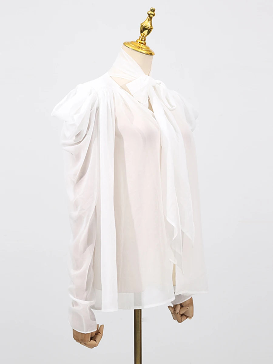 Tie-up sleeve blouse styled for an elegant setting, with fluid fabric movement and minimal accessories
