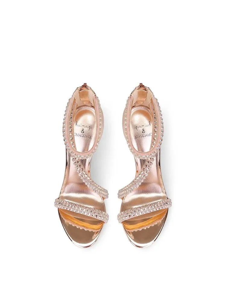 a metal studded sandal with rhinestones and a thin heel.