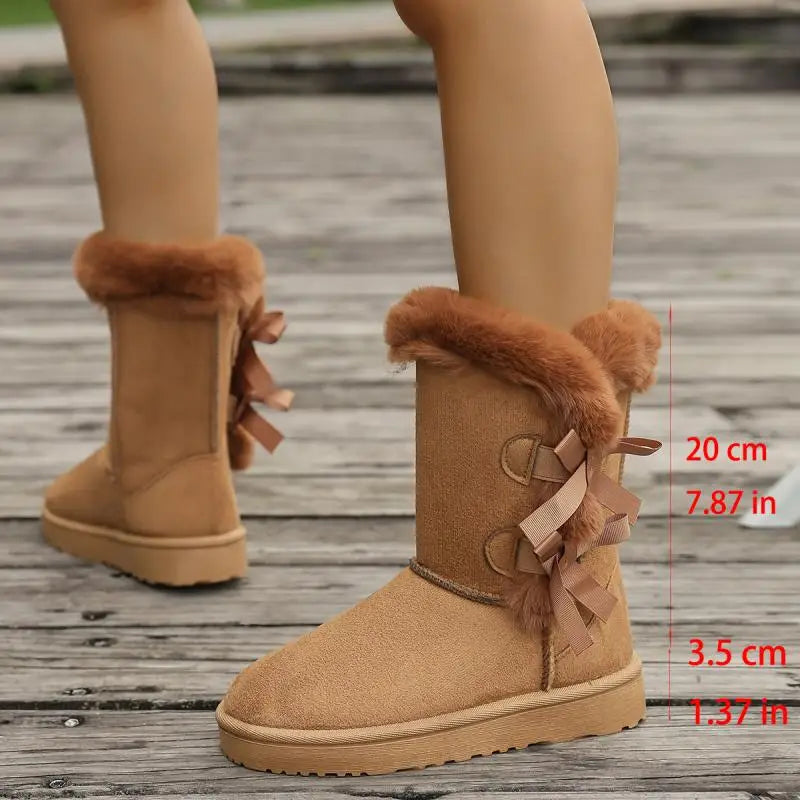 Close-up of bowknot detail and plush lining on snow boots