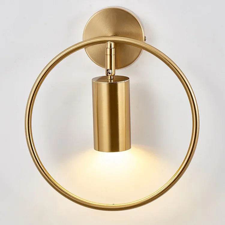 Minimalist gold wall lamp used as bedroom accent lighting