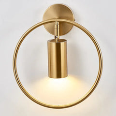 Minimalist gold wall lamp used as bedroom accent lighting