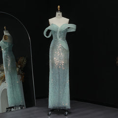 Teal evening gown on a mannequin against a black background