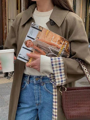 Modern chic trench coat worn with jeans and boots for high street style