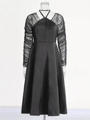 Modern club semiformal black dress with halter neckline

