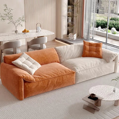 “Modern cream-toned designer sofa styled in bedroom nook”

