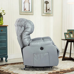 Side view of a grey electric power recliner lift sofa chair background with antique table, cabinet and framed paintings in the background.