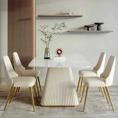 “Modern rectangular dining table with rock slab top and gold fluted base”

