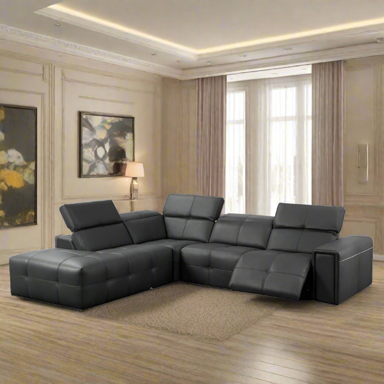 A modern gray leather sectional sofa with a corner reclining design, placed in a luxurious living room setting.