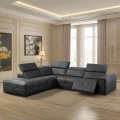 A modern gray leather sectional sofa with a corner reclining design, placed in a luxurious living room setting.