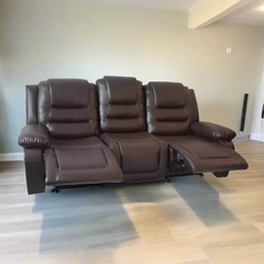 A modern spa salon chair in a dark grey, grey, and black colour scheme, featuring leather upholstery and a wooden frame, placed in a room with light flooring.