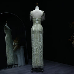 Elegant green lace dress on a mannequin against a dark background