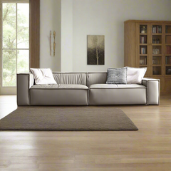 Modern design wooden frame leather sofa with a metal accent, displayed in a bright living room setting.
