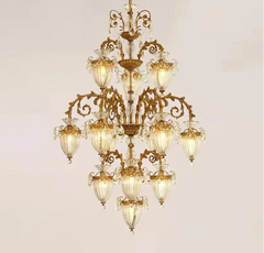 Multi-tiered brass and glass chandelier illuminating large entryway