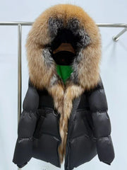 Close-up of the plush fur hood trim highlighting dense texture and a soft edge that frames the opening in studio lighting.