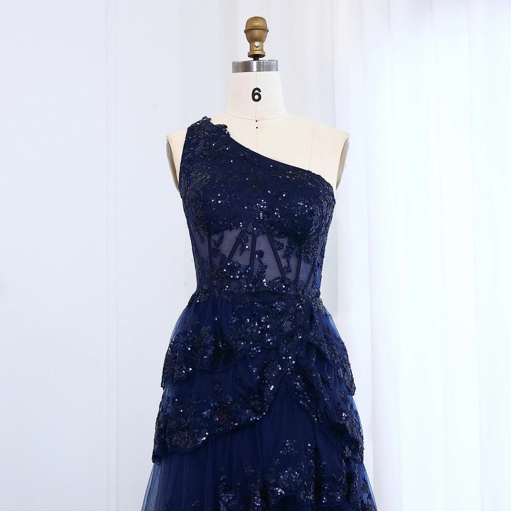One-shoulder neckline and bodice detail on a floor-length prom dress