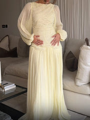 Neutral maxi dress with soft folds and vintage-inspired silhouette