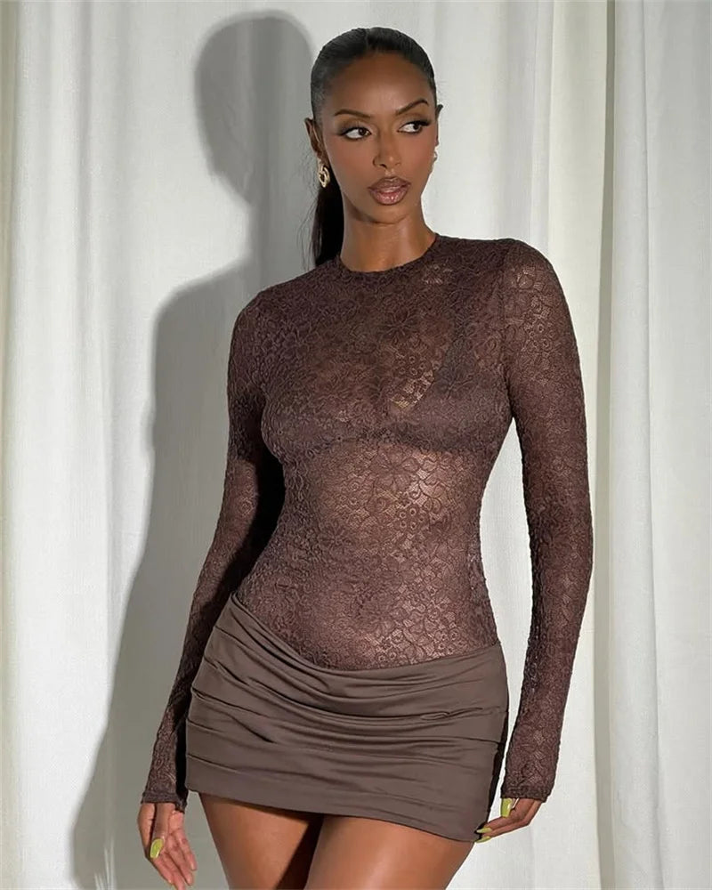 Evening-ready look of a brown lace mini dress styled with minimal accessories, emphasizing the long sleeves and sleek silhouette.