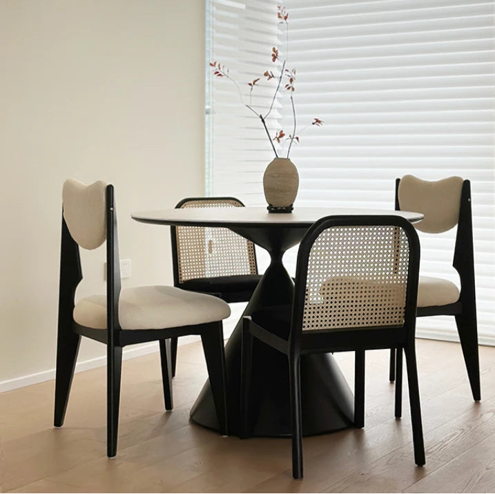round white dining table with rotating center and black sculptural base
