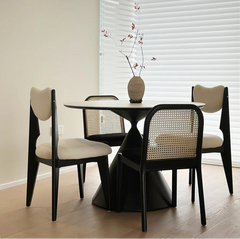 round white dining table with rotating center and black sculptural base