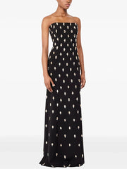 Close-up of the embellished texture across the dress, showing repeated motif detailing and a smooth base fabric with a refined finish.