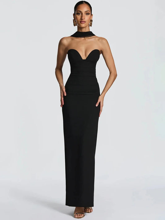 Woman wearing a black strapless gown on a white background