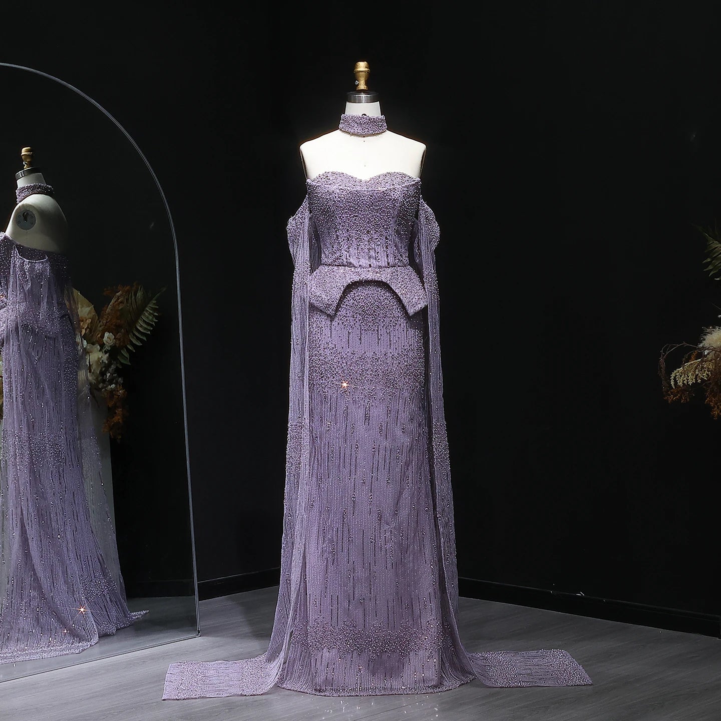 A full-length shot of the beaded formal dress, highlighting the long sleeves.