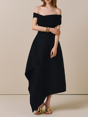 “Off-shoulder black midi dress styled with minimal heels and clutch”

