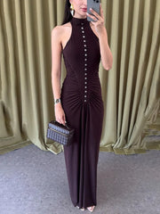 A woman modeling a black off-shoulder ruched maxi dress.