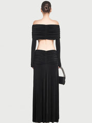 Pleated long skirt styled with a matching fitted top on a plain background