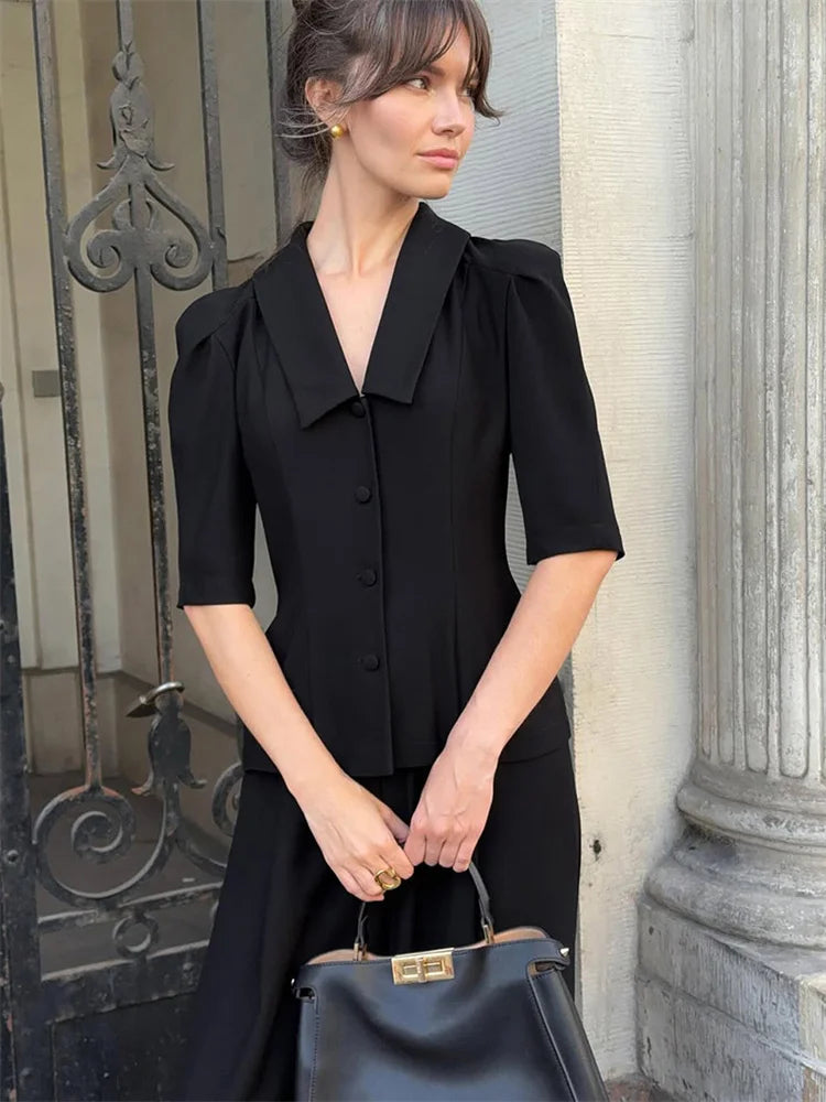 High-waist ankle trousers paired with a structured V-neck shirt